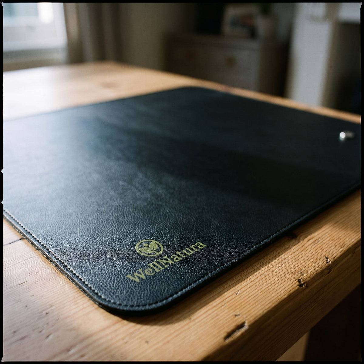 Close-up of the pebble grain vegan leather and the WellNatura logo on the mat