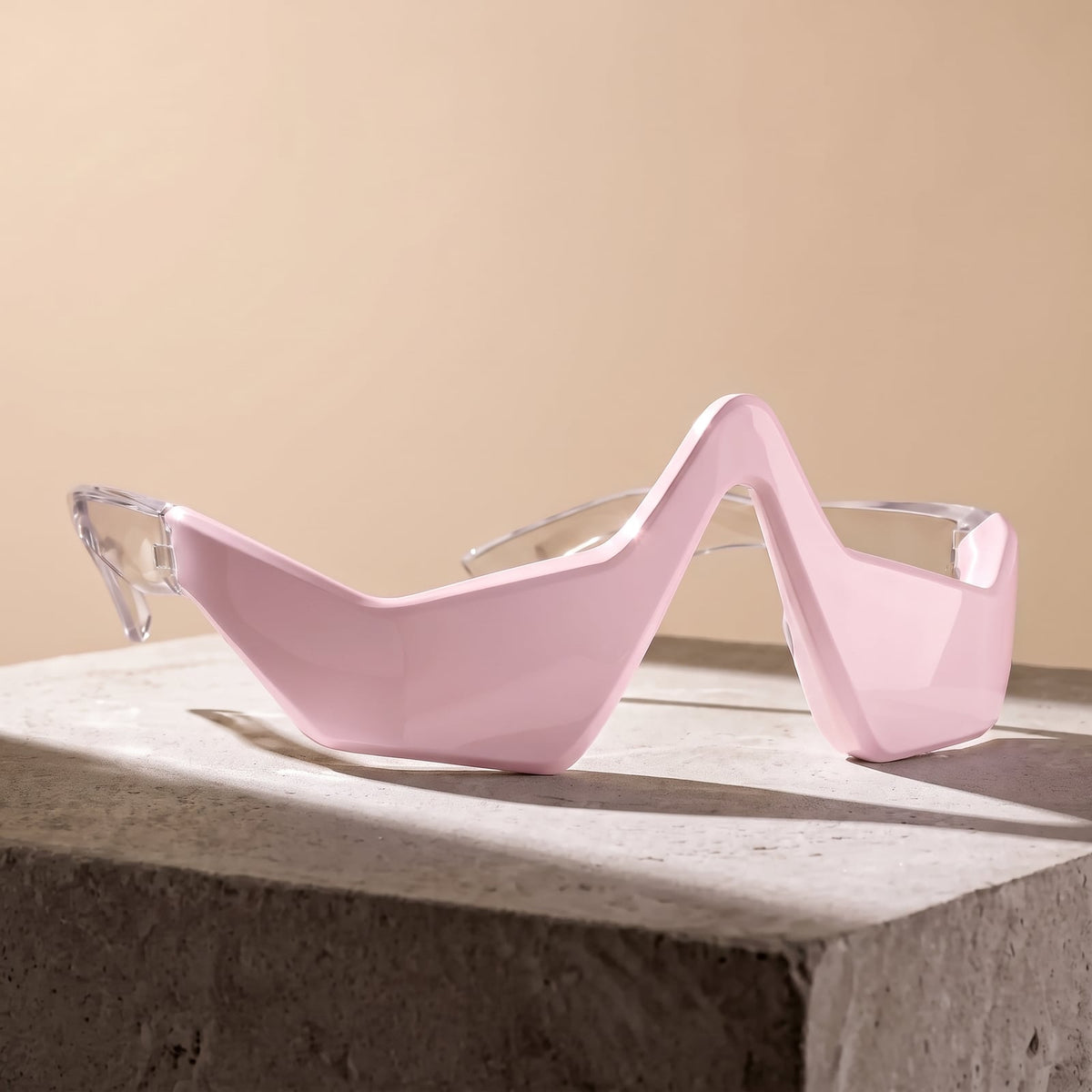 Rejuva Eyes under-eye device in pink on a stone plinth
